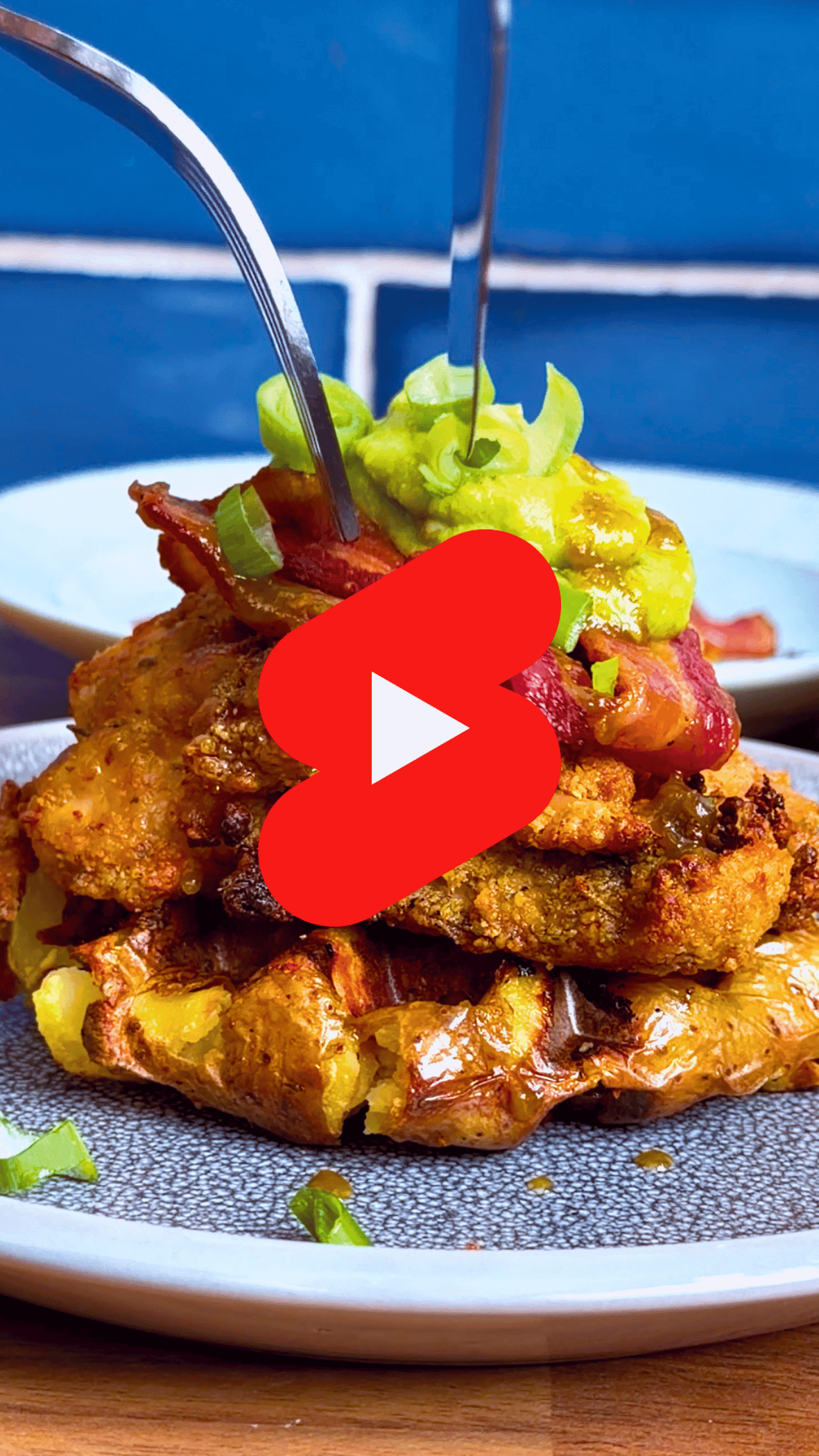 Crispy potato waffles with chicken and hot sauce